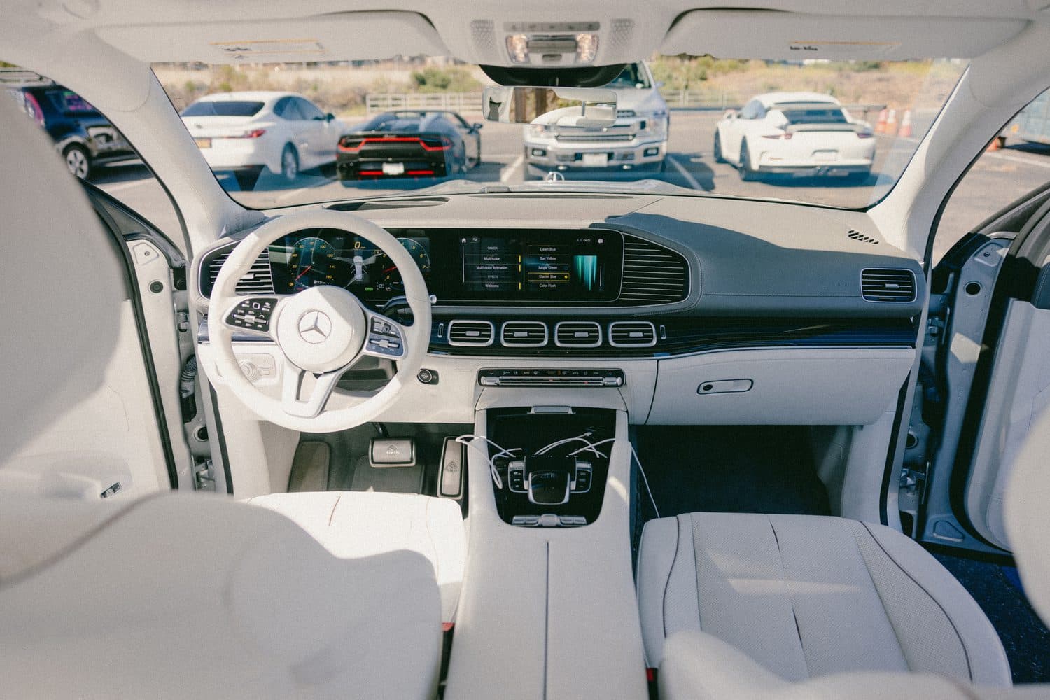 Mercedes-Maybach GLS front cabin — Mercedes steering wheel, twin dashboard screens and center console in white leather
