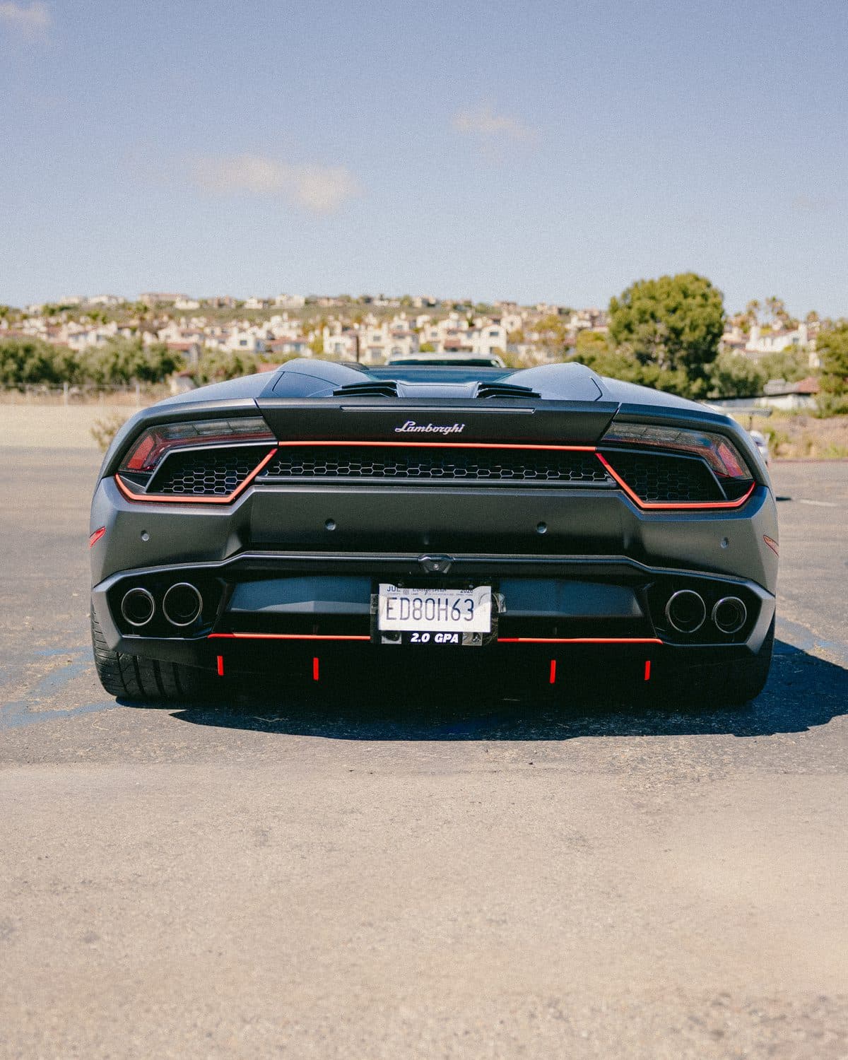 Matte-black Lamborghini Huracán EVO Spyder, rear, staged in Orange County