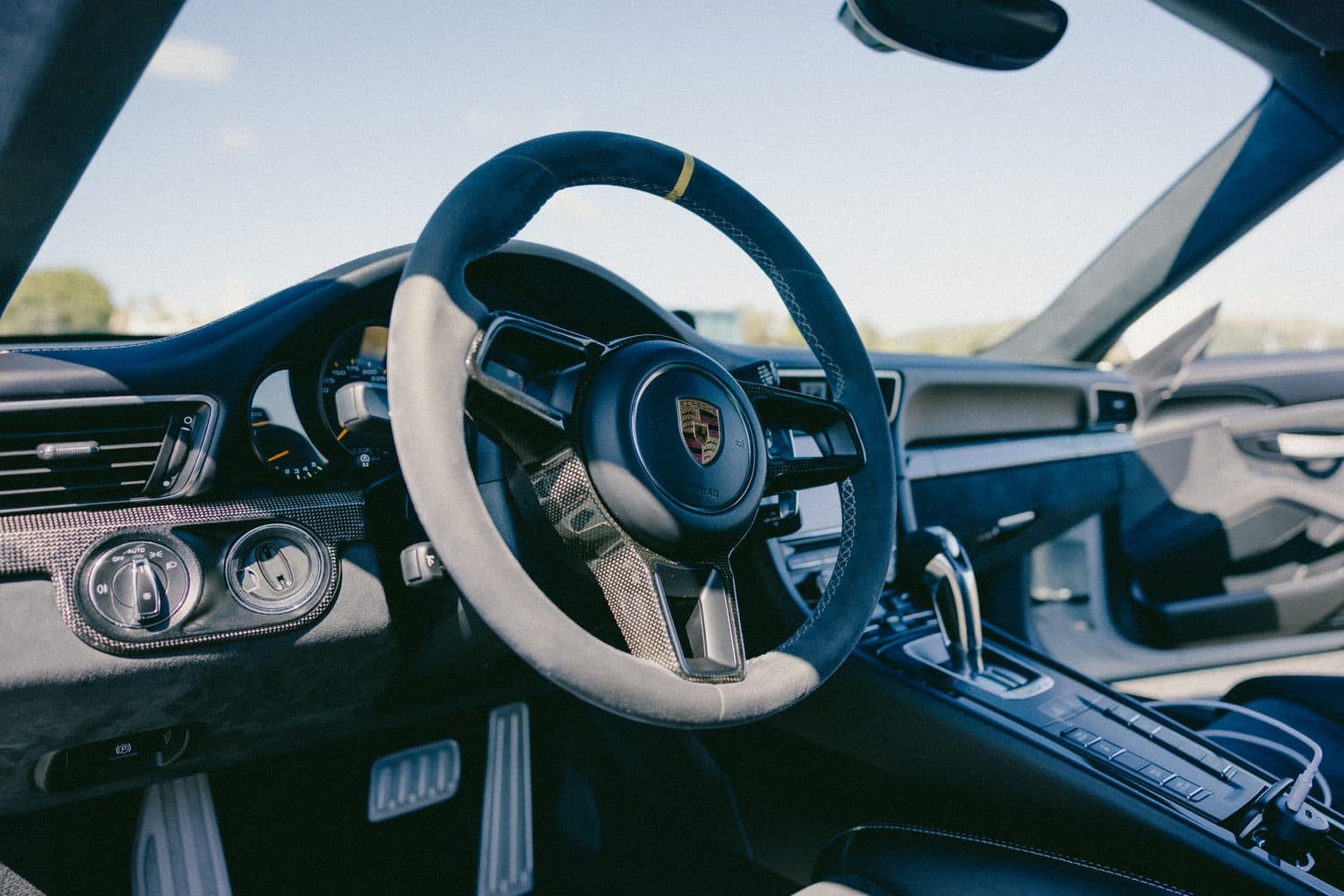 Porsche 911 GT3 RS interior — Alcantara steering wheel with yellow top marker, black gauges and carbon trim